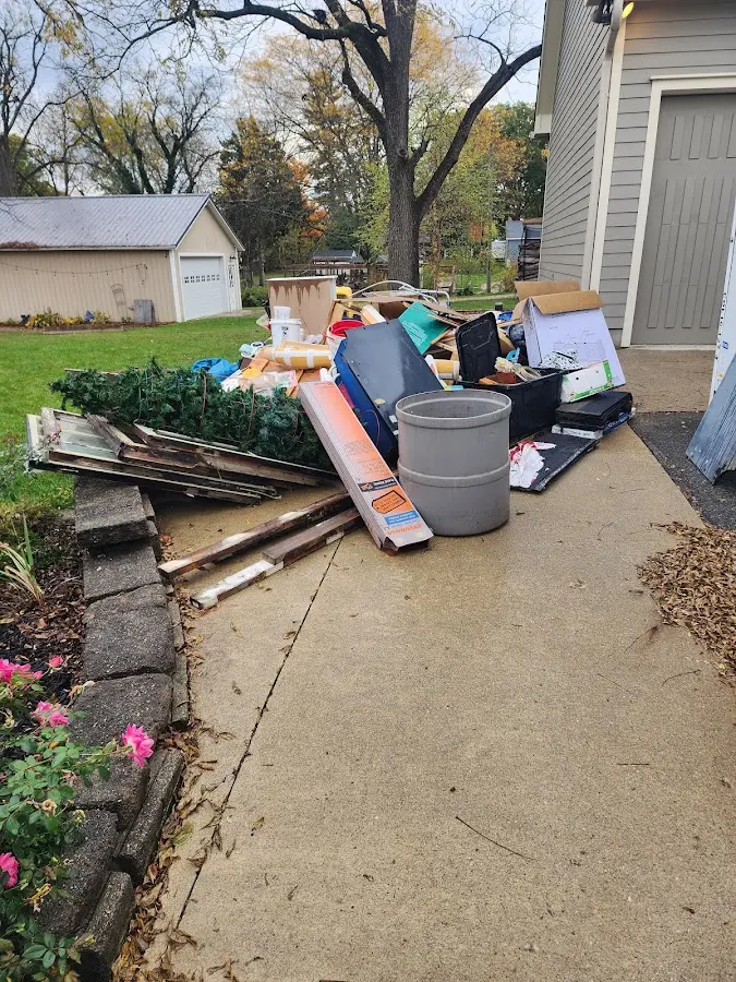 Dumpster being loaded with debris for Estate Cleanout Dumpster Rental in Alpine
